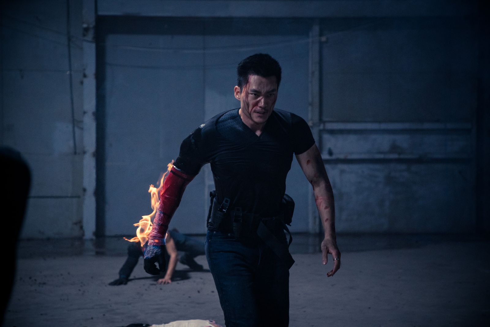 Kuang Feng walking with a burning robotic arm
